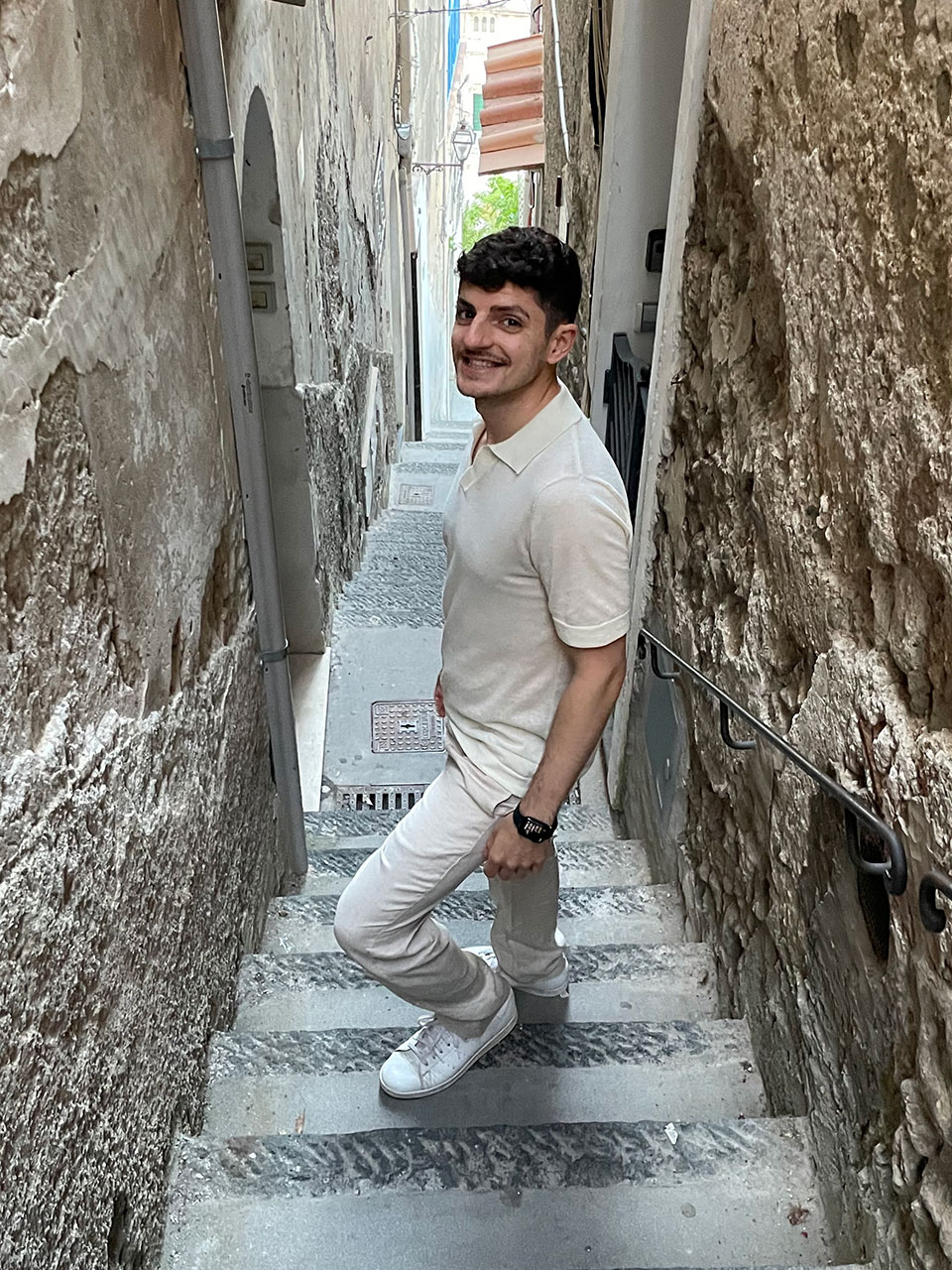 Nabil on a narrow stone staircase